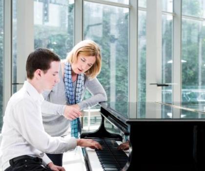 Teacher and student with a piano